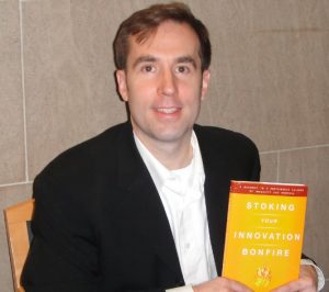 Braden with a copy of Stoking Your Innovation Bonfire
